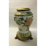 A late 18/early 19c Oriental famille verte baluster vase decorated with exotic bird, flowers and