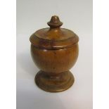 A 19c Fruitwood nutmeg grater in the form of a turned wood cup on stand with lift of cover