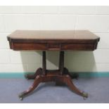 A Regency rosewood fold over card table with brass rail inlay raised on a stretcher frame with