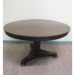 A William IV rosewood circular tilt top breakfast table on a facet column with tripartite base and