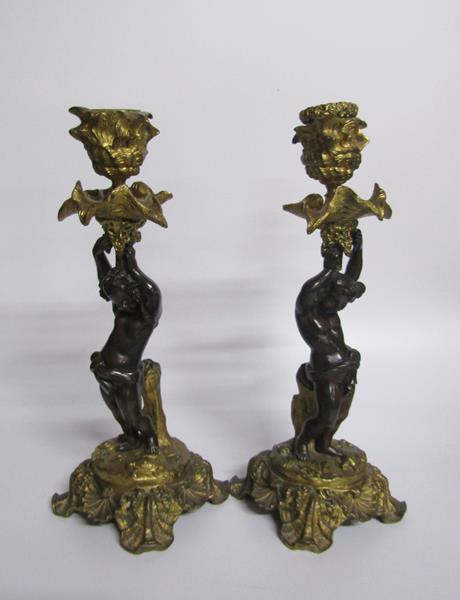 A pair of late 19c gilt and patinated bronze candlesticks with putti columns supporting the socles - Image 2 of 5