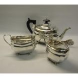 A three piece silver tea service of squat baluster form comprising a teapot, sucrier and cream