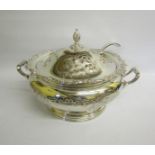 A silver plated two handled soup tureen on a circular stepped base. Chased and embossed with a