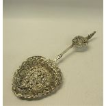 A late Victorian silver decorative tablespoon with cast and pierced ovoid bowl, with terminal