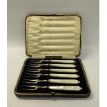 A boxed set of six pearl handled silver prong pickle forks, makers mark for James Dixon & Son,
