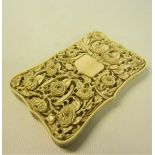 A late 19c ivory card case carved in high relief with panels of leaf and flowers, and through the
