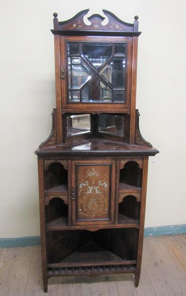 A late Victorian rosewood full height corner cupboard with mirror back and upper astragal glazed