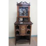 A late Victorian rosewood full height corner cupboard with mirror back and upper astragal glazed