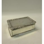 An early Victorian silver table snuff box of rectangular form, the hinge cover with a cast border of