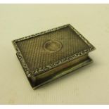 An early 20c Georgian style silver snuff box of rectangular engine turned form with cast leaf and