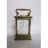 A late 19c striking French carriage clock in glazed brass case with chamfered corner posts and