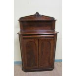 A Victorian mahogany chiffonier with moulded back board and upper shelf on turned supports having