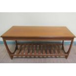A G Plan teak low table of rectangular form with moulded edge having a slatted under tier shelf.