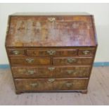 A mid Georgian figured walnut veneered cross banded bureau with fall front and fitted interior