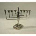 A silver nine branch Menorah, makers mark Britton, Gould & Co, Birmingham 1932. 21cms w x 20cms h.