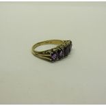 A gold five stone ring set with five cut Amethysts. Ring size P/Q.