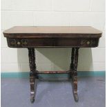 A late Georgian figured mahogany fold over card table the table top with brass rail inlay cross