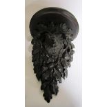 A 19c Black Forest acorn and oak leaf carved wall bracket with a boars head mask. 28cm w x 39cm h.