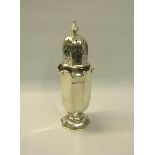 A Edwardian silver sugar caster of facet form with gadroon rolling upper rim on a circular step dome