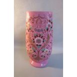 A late 19c pink overlay glass vase, painted with sprays of flowers, 31cms h.