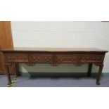 An early 19c Cherrywood four drawer dresser base with fret cut apron supported on square carved