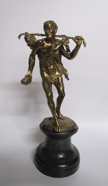 A 19c gilt bronze figure of a fawn travelling with an animal skin leotard, a stick over shoulder