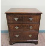 A mid Georgian style figured walnut veneered small chest of three long drawers. The top and drawer