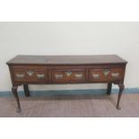A late 18c Midlands oak three drawer dresser base, the drawers with pierced brass back plates and
