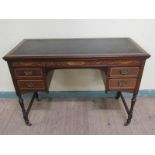 A late 19c/early 20c mahogany marquetry decorated writing table with tooled green leather insert and