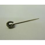 A gold stick pin set with gold Diamond horseshoe. 5.5cms l.