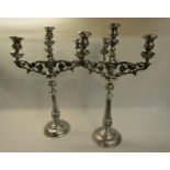 A pair of 19c silver three branch candelabra's with knot fluted tapering columns and raised on