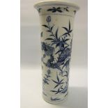 A 19c Chinese cylindrical vase decorated blue on white with dragons amongst flowers. Four