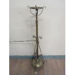 A late Victorian brass oil lamp stand with electrical fittings. Adjustable column having oil lamp