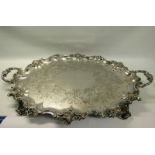 A mid Victorian silver two handled tray with a raised and shaped leaf and scroll formed border,