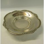 Early 20c Continental silver dish with a shaped raised and shell cast upper border supported on
