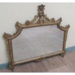 A mid Georgian style gilt wooden stucco wall mirror within a serpentine gilded frame having an