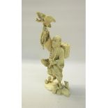 A Japanese Meiji period carved ivory figure of a fisherman holding his Cormorant aloft in his
