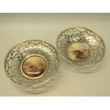 A pair of circular silver bowls, pierced and with James Stinton Royal Worcester bases, both