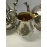 A mid Victorian four piece silver tea service of embossed and chased baluster form. Makers mark