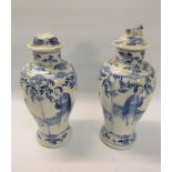 A pair of 19c Oriental crackleware vases of baluster form, decorated blue on white with scholars and