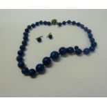 A Lapis Lazuli graduated bead necklace together with pair of earrings. Necklace 36cms l.