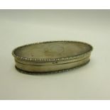 An Edwardian silver toothpick box of oval form with beaded rim, engine turned and enclosed by a