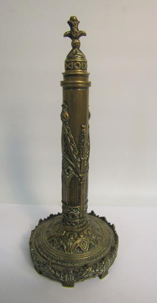 A 19c brass fan holder embossed and engraved in Gothic form, the columns supported on a circular