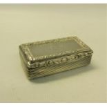 A William IV silver snuff box of rectangular form, the box with ribbed decoration and leaf and