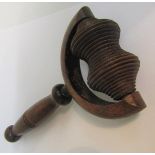 A 19c Sycamore massager with a rib carved roller in a prong frame with a turned wood handle. 19cms