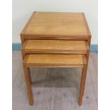 A nest of three 1970's teak occasional tables, the largest 53cms w x 53cms h.