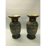 A pair of Meiji period cloisonné ceramic satsuma vases on blue backgrounds, decorated with panels of