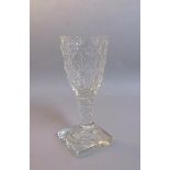 A 19c square base wine glass with a diamond and circle cut bowl on a facet cut stem. 13cm h.