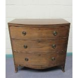 A late Georgian mahogany bow front chest of three long graduated drawers with circular stamped brass