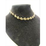A 9ct gold necklace of linked form - 36cms l. 13.g.